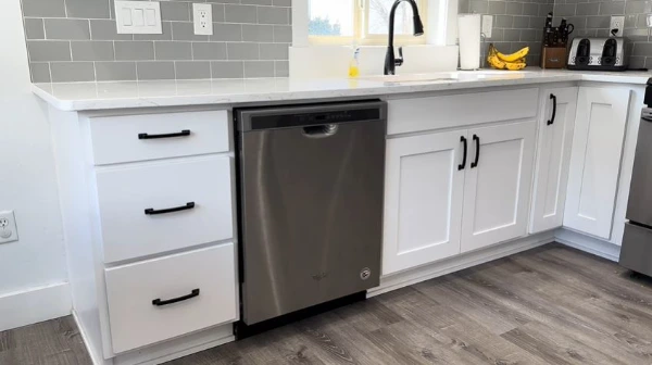 Technician servicing a dishwasher in an Abilene, TX home
