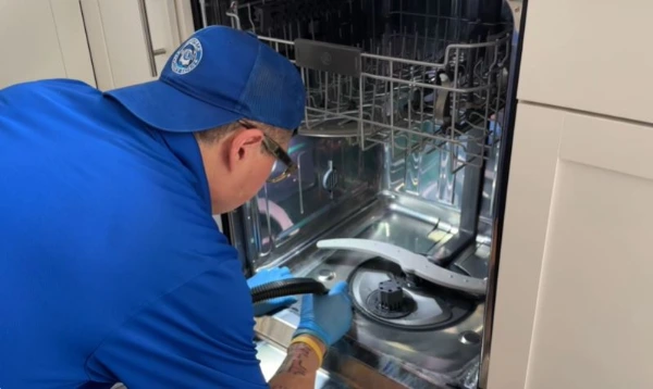 Technician replacing a dishwasher drain pump in Abilene, TX