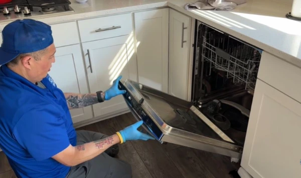 Technician diagnosing a dishwasher repair issue in Abilene, TX