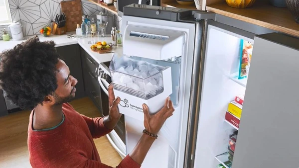 Technician repairing a freezer in an Abilene, TX home