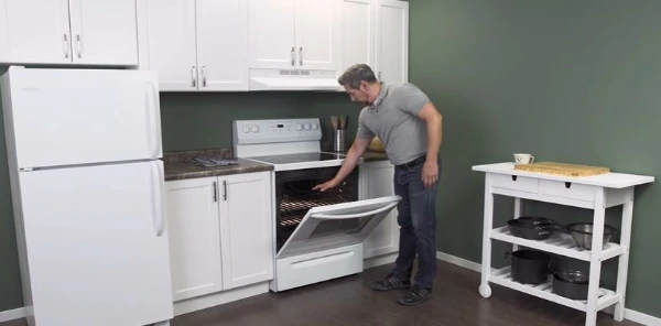 Technician repairing a microwave in an Abilene, TX home