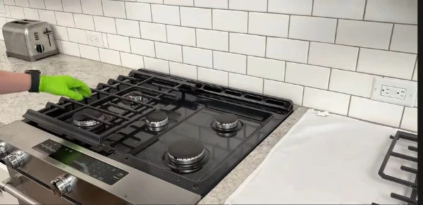 Technician repairing a stove in an Abilene, TX kitchen